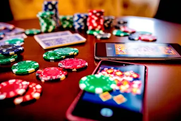 A professional dealer in a tuxedo greeting players at the roulette table, symbolizing the authentic live casino feel at FOOTBALL BET.