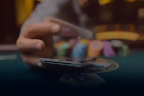 FOOTBALL BET Games — Explore our rich library of casino classics A woman smiling while playing online games on her laptop, surrounded by neon casino elements, showcasing FOOTBALL BET’s diverse game collection.